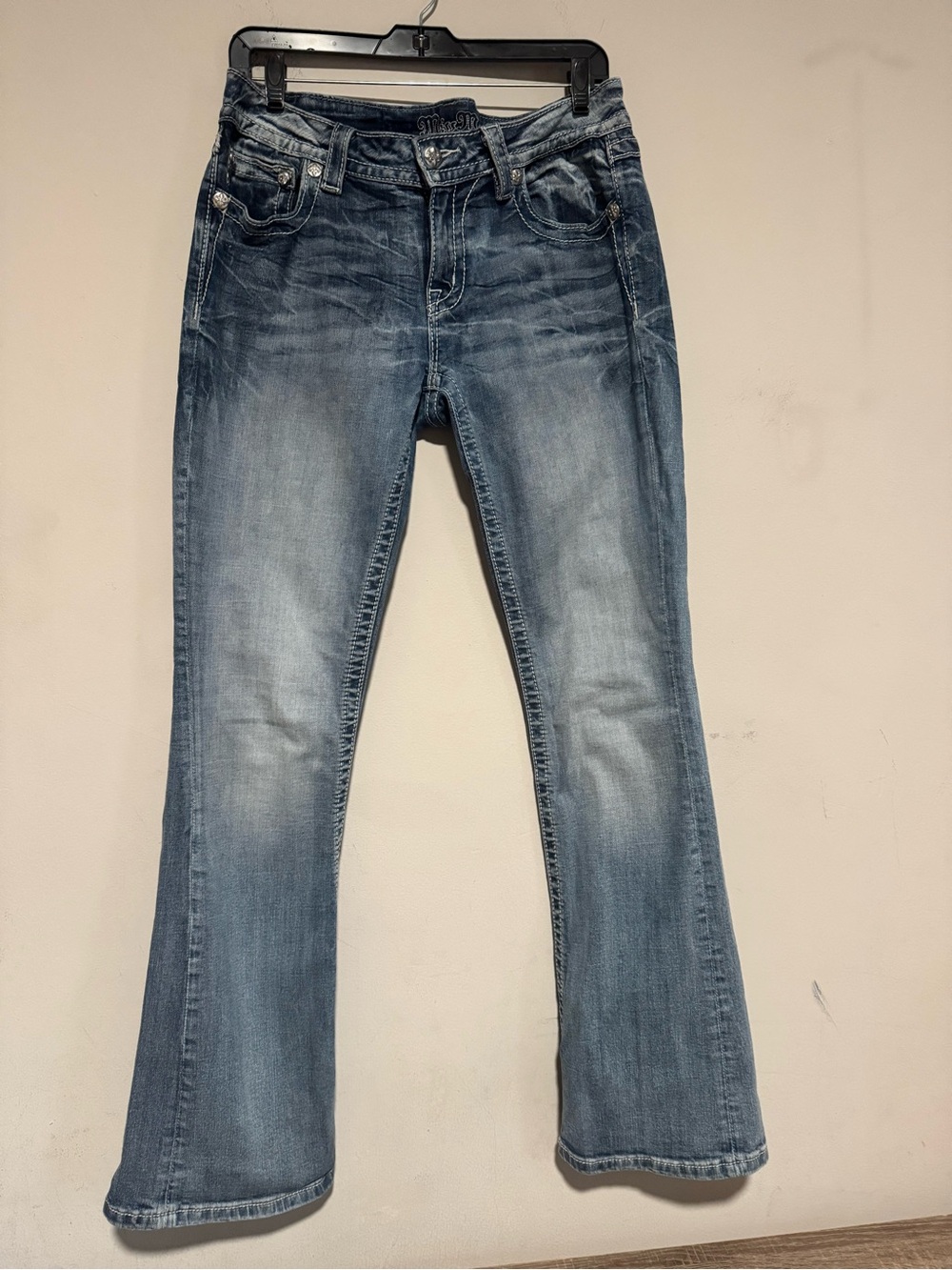 Miss Me medium wash bootcut denim jeans featuring classic whiskering a